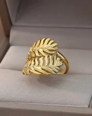 Rings for wedding, a pair of artificial gold-plated wedding rings with a cubic zirconia stone displayed on a silk cloth.